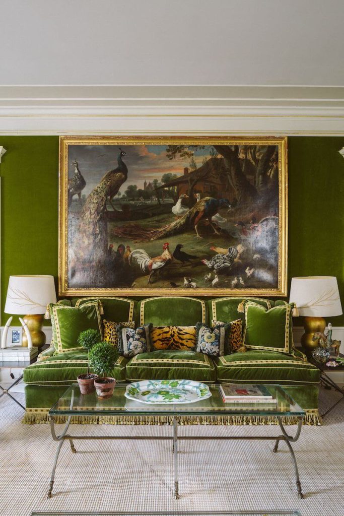 The Tory Burch sofa with an oversized bird painting hanging above. 