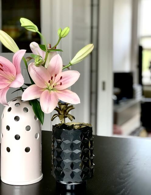 Pink lilies in a contemporary vase brighten up a casual room.
