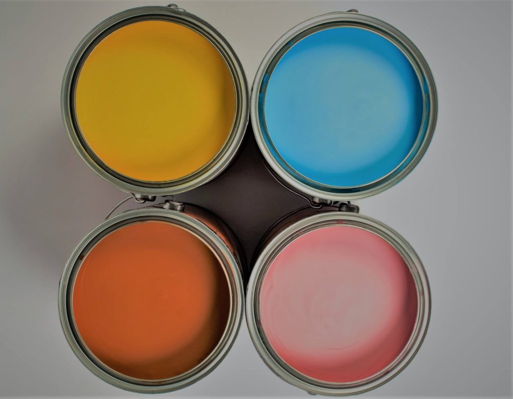 Four paint cans filled with colorful paint.