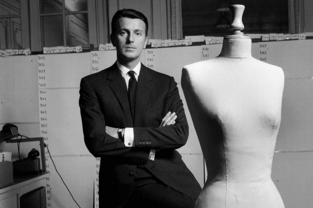Givenchy next to a dress form in the 1960s. 