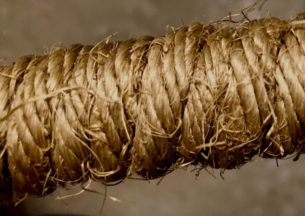 Twisted jute rope exposing staple fibers. 