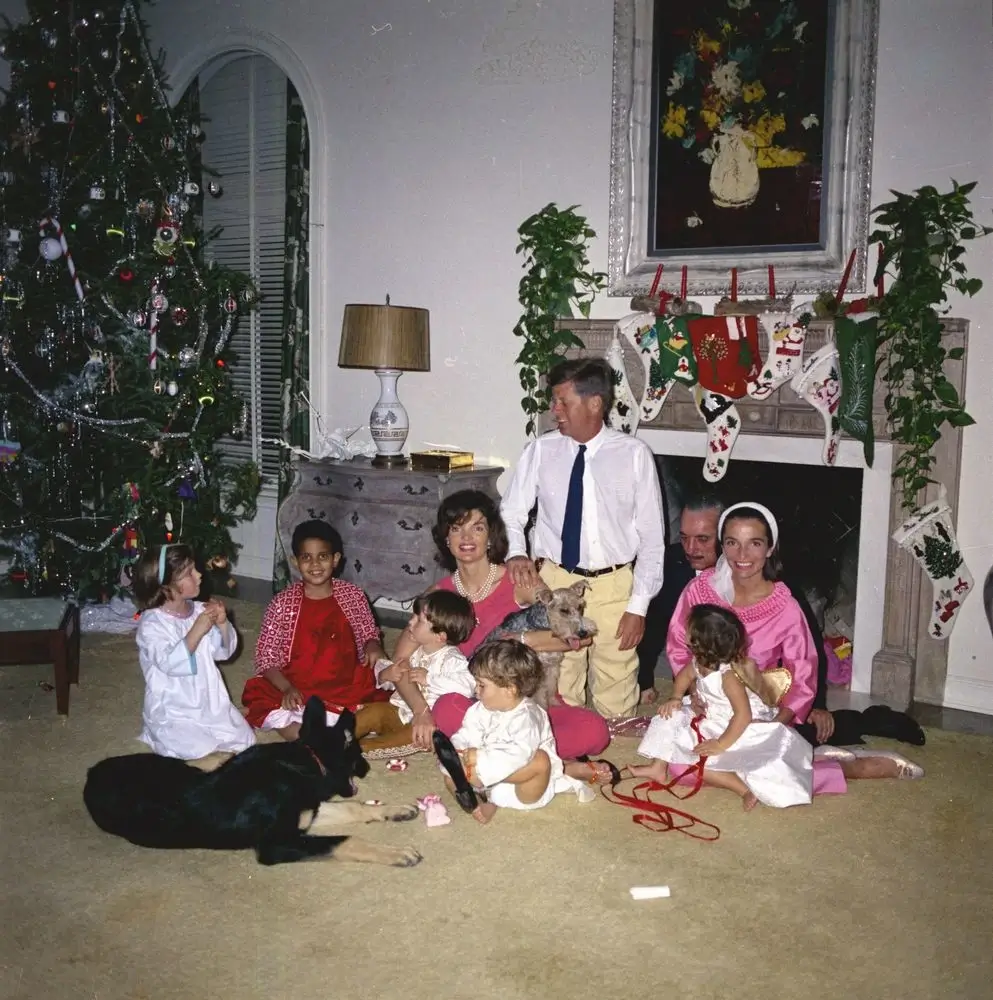 The Kennedy family gathered in front of the fireplace in the Palm Beach residence of C. Michael Paul on Christmas day 1962. 
