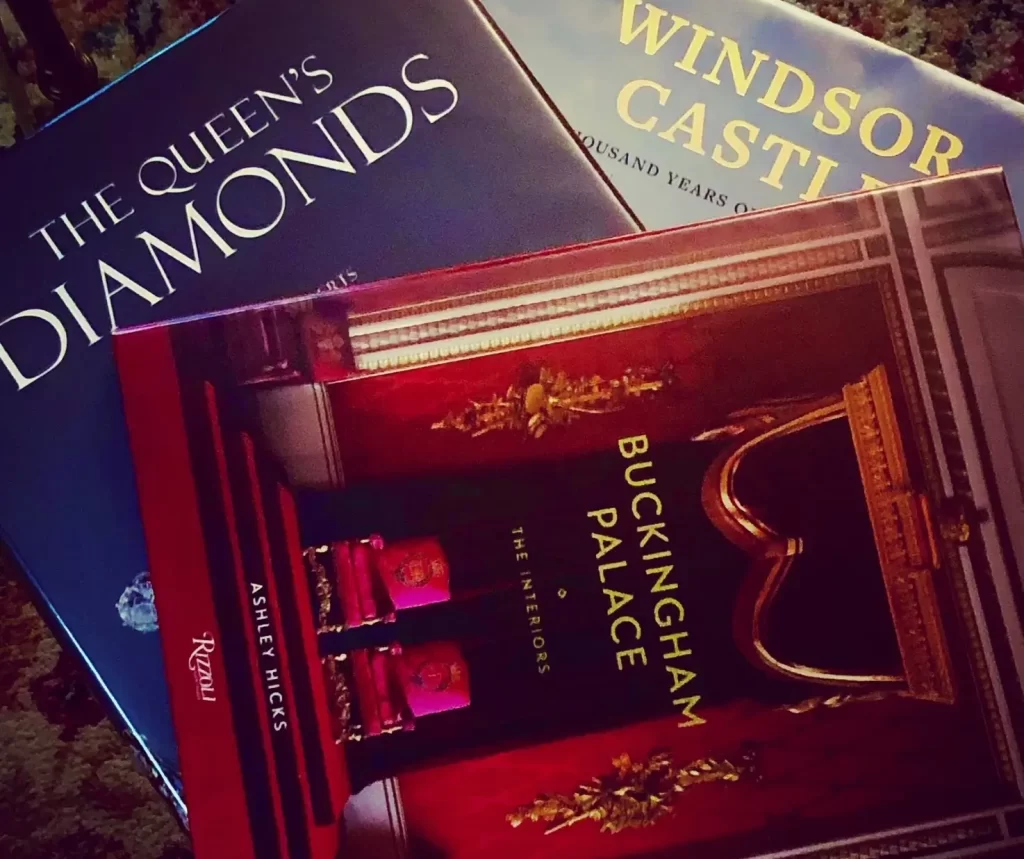 A selection of 3 coffee table books about royal life: Buckingham Palace, The Queen's Diamonds, and Windsor Castle.
