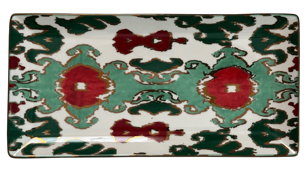 A porcelain trinket tray featuring gilding and a hand-painted ikat motif.