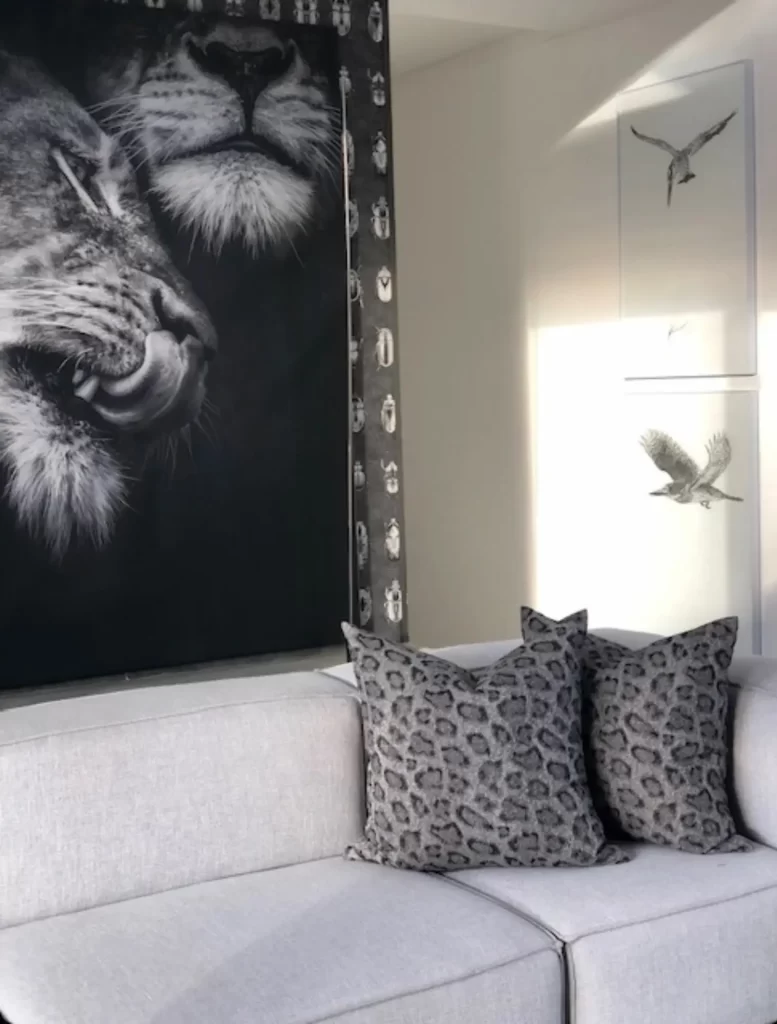 A black and white sitting room featuring snow leopard print cushions.